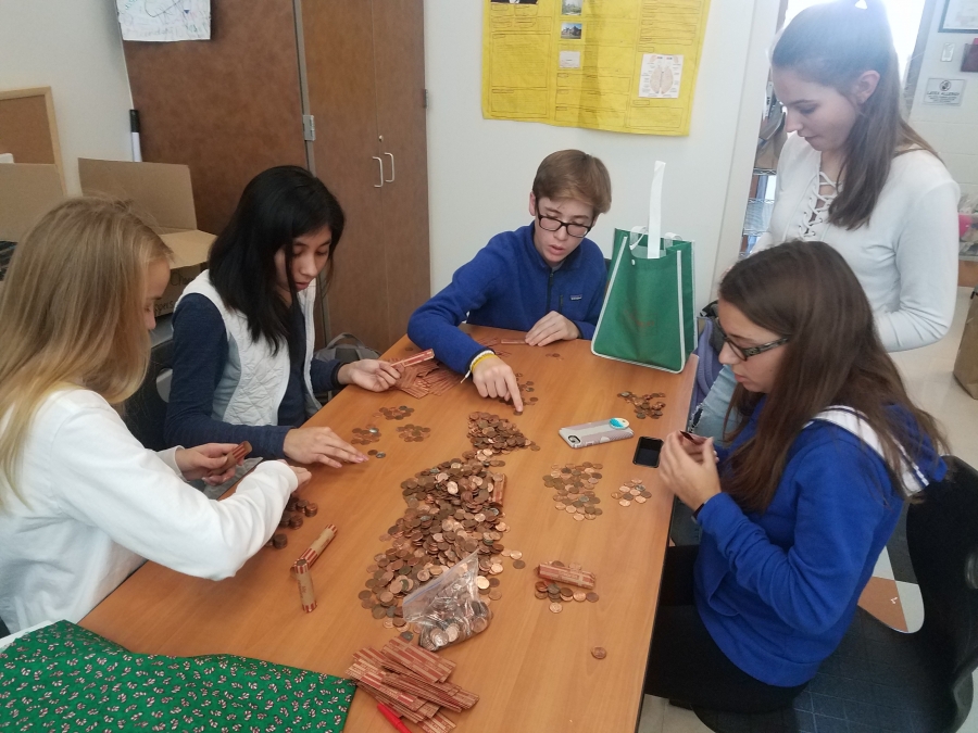 students counting money from the change for change day to raise money for the BLOC house.